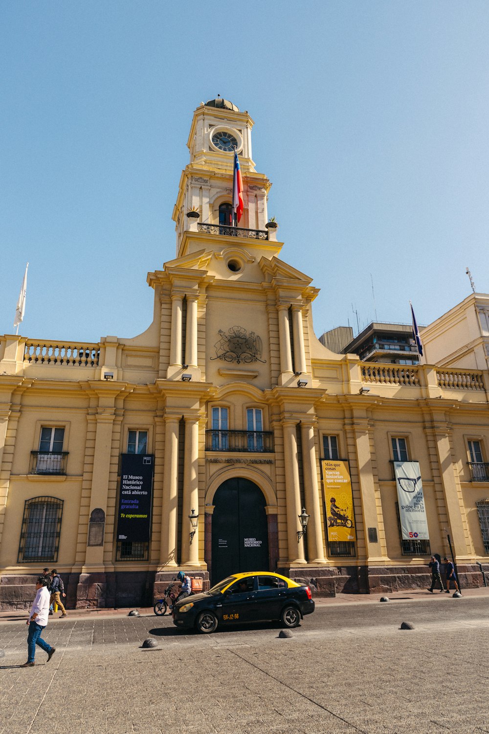 a large yellow building with a clock tower