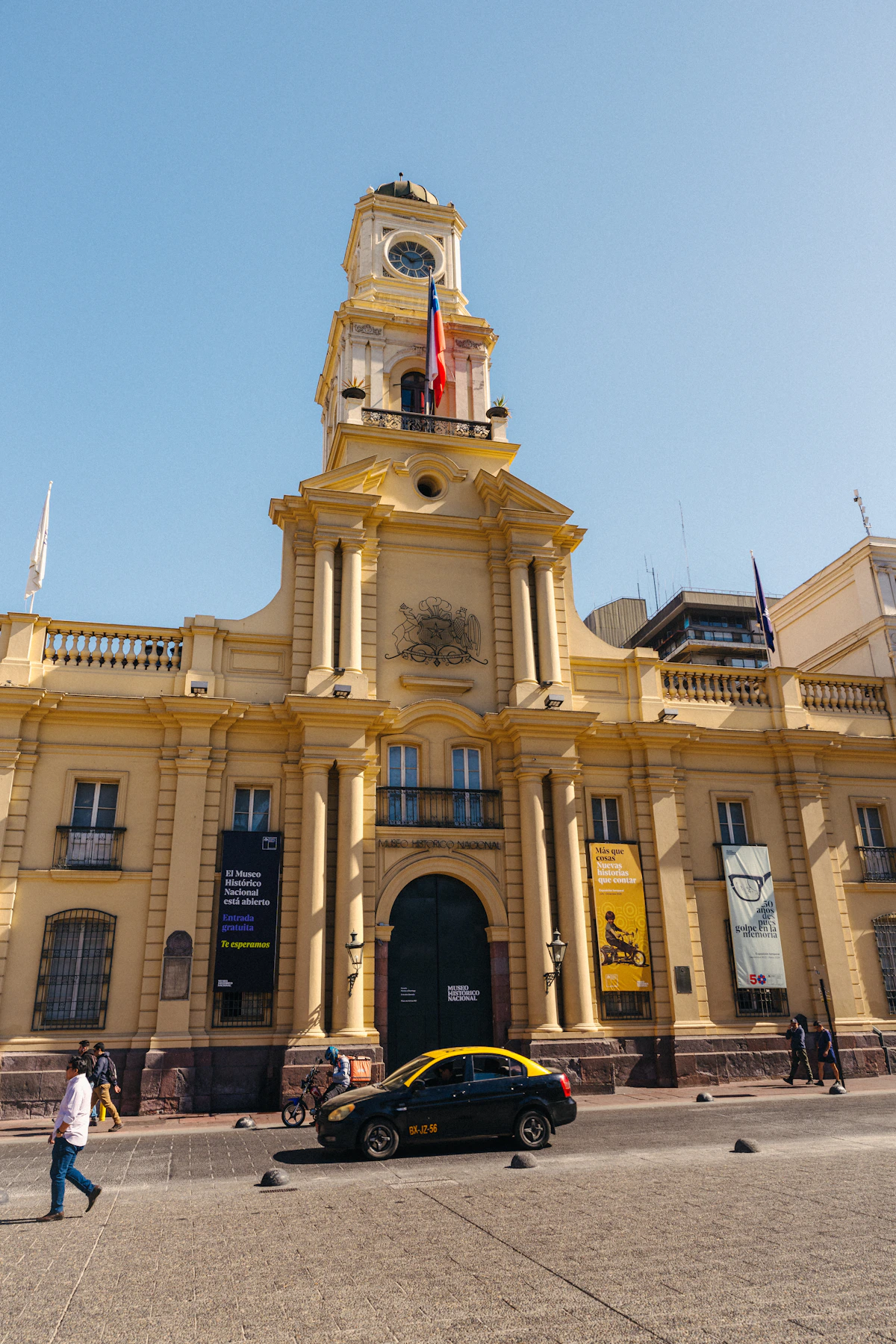 A historic yellow civic building with a clock tower in central Santiago