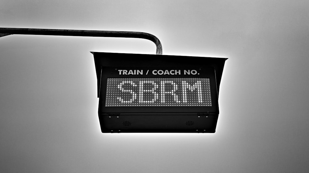 a black and white photo of a train sign