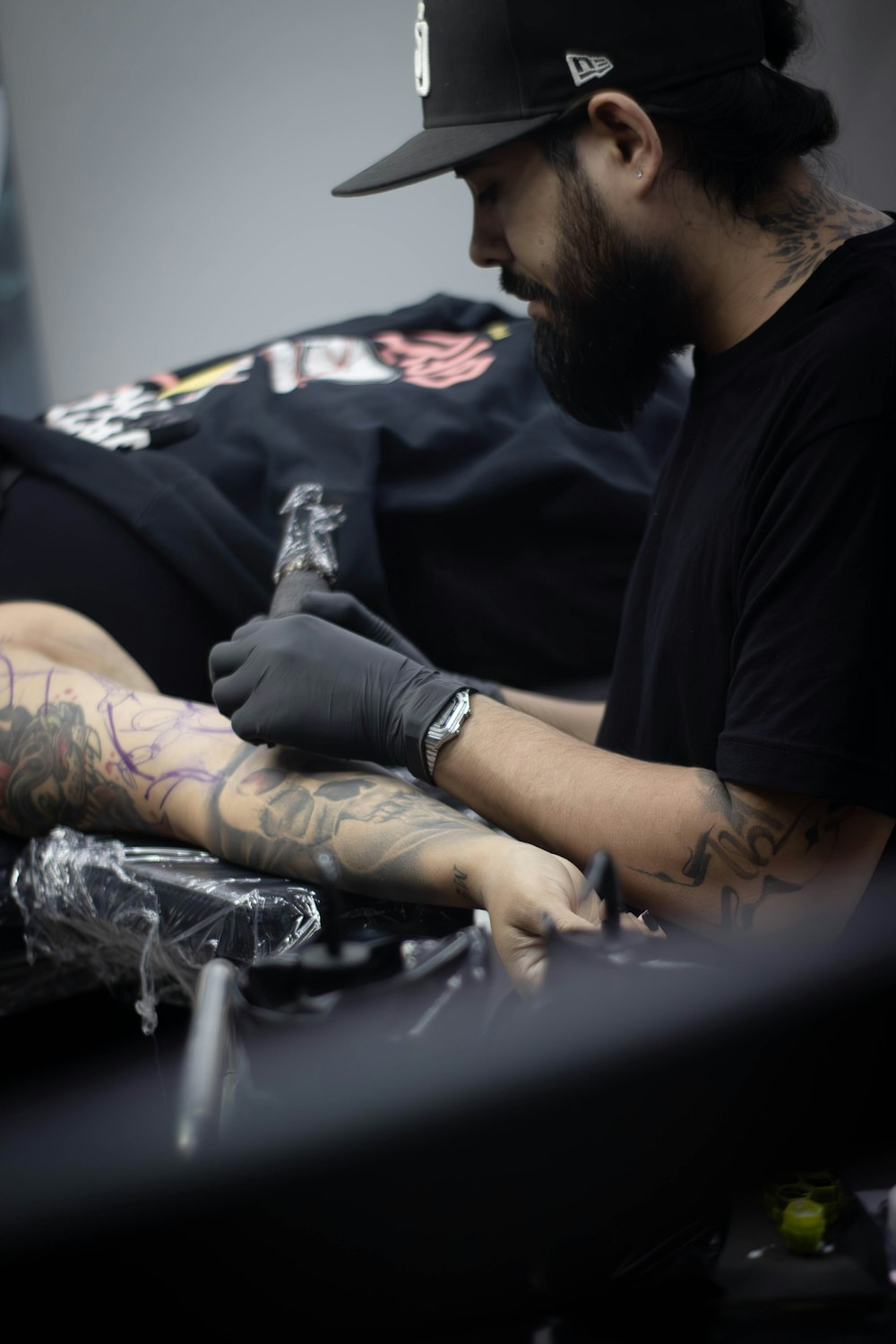 a man getting a tattoo on his arm