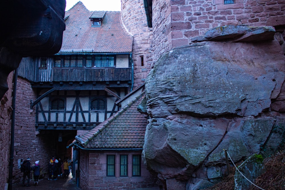 a narrow alley way with a stone building on the other side