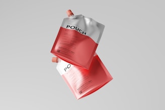 a pair of red and white packets floating in the air