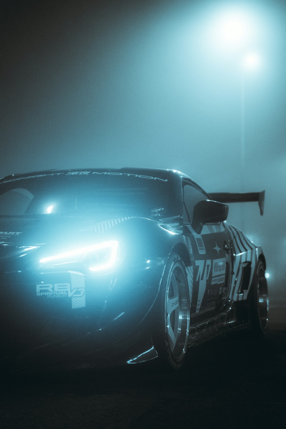 a car driving on a foggy road at night