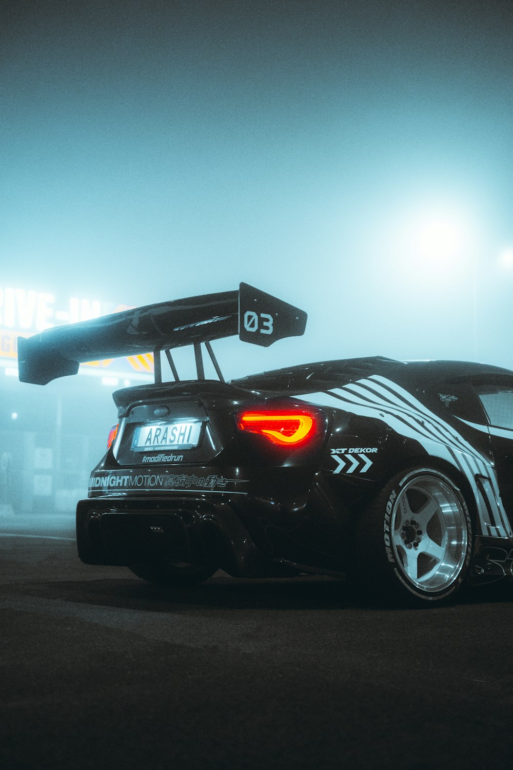 a black sports car parked in a parking lot