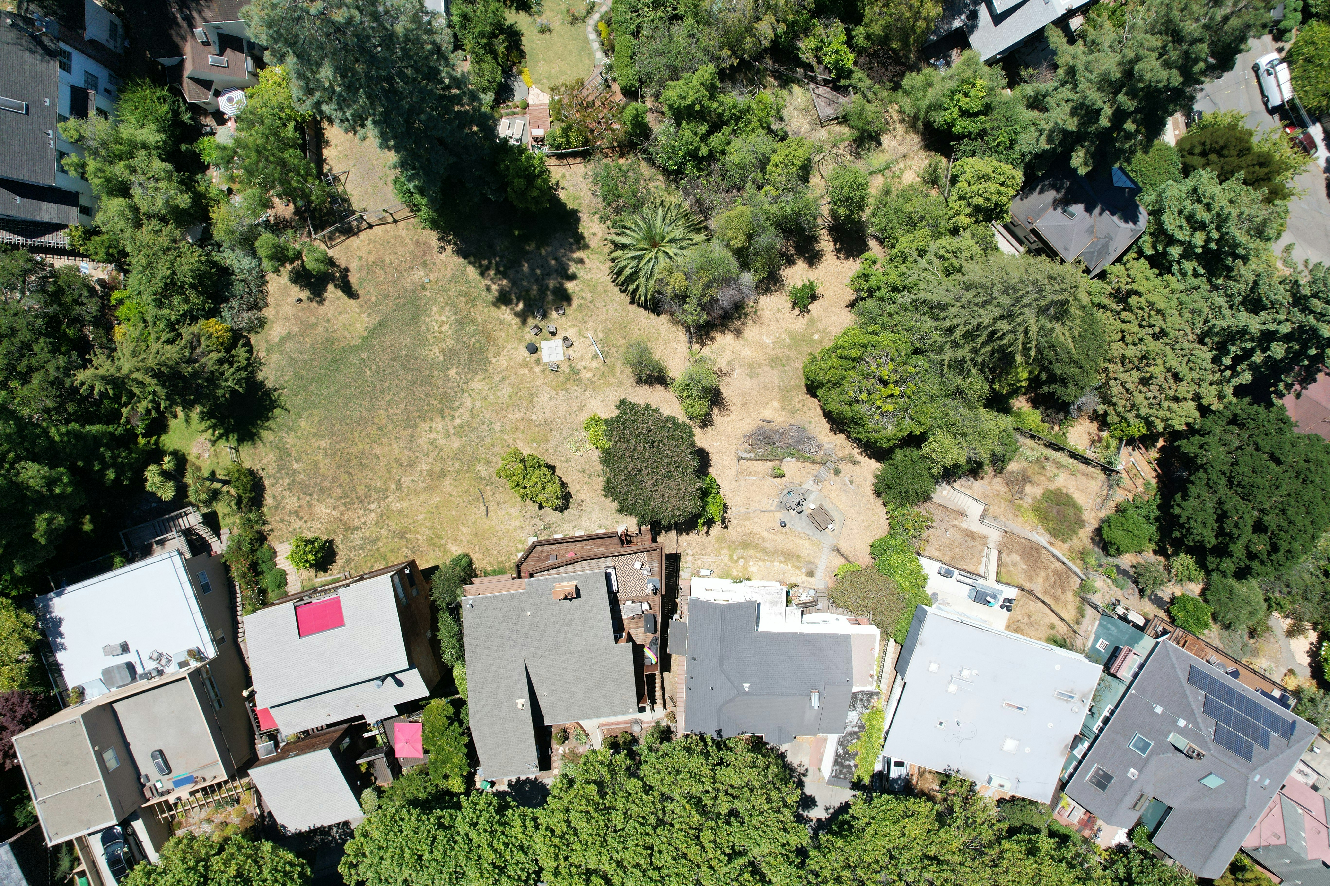 an aerial view of a house surrounded by trees