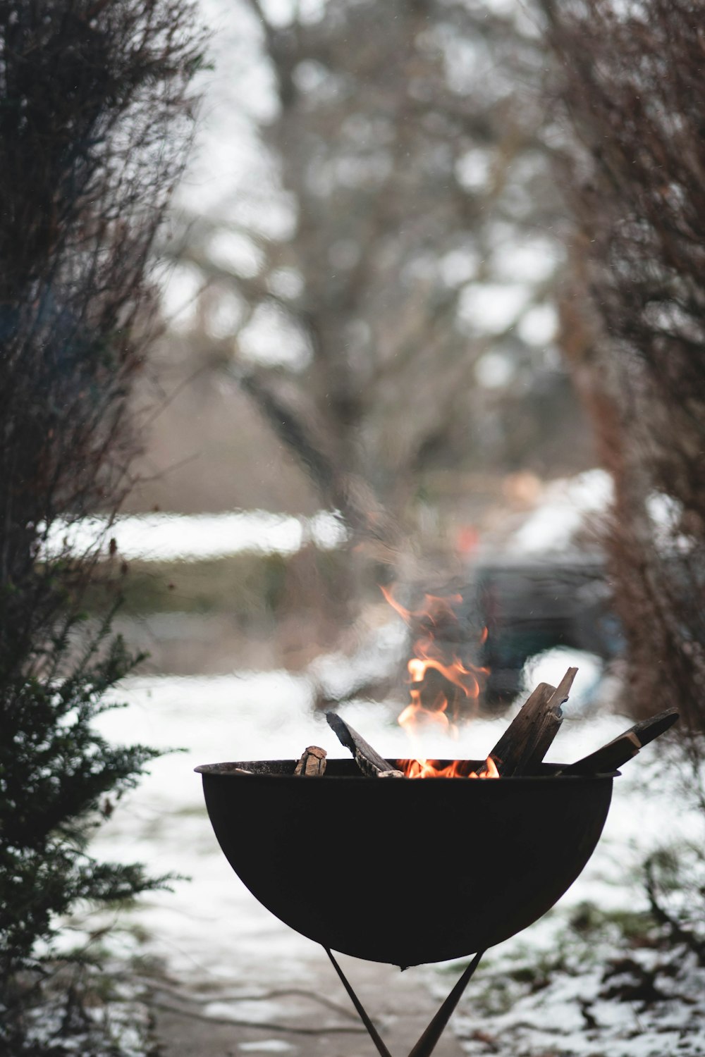 a bbq grill with a fire burning in it