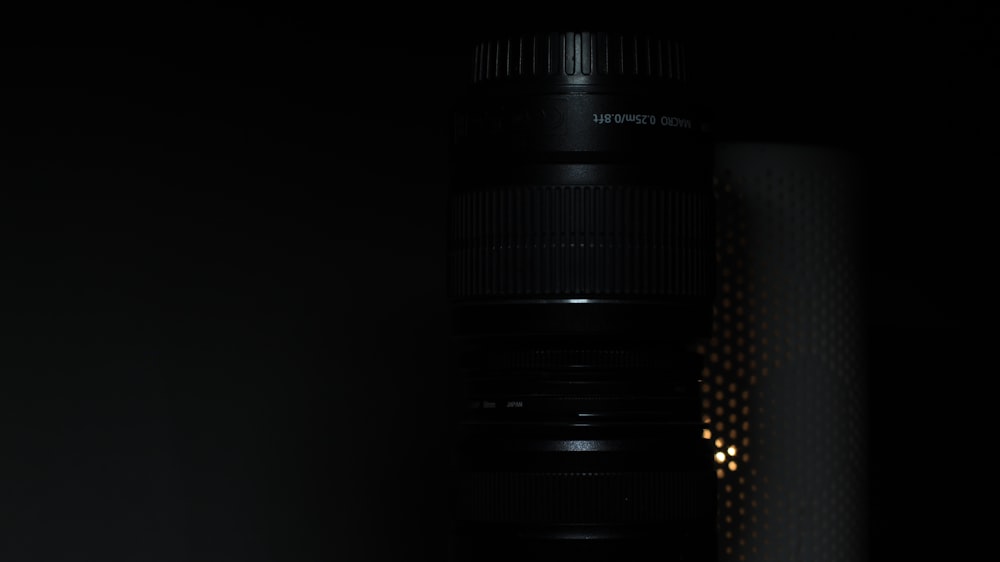 a close up of a camera lens in the dark