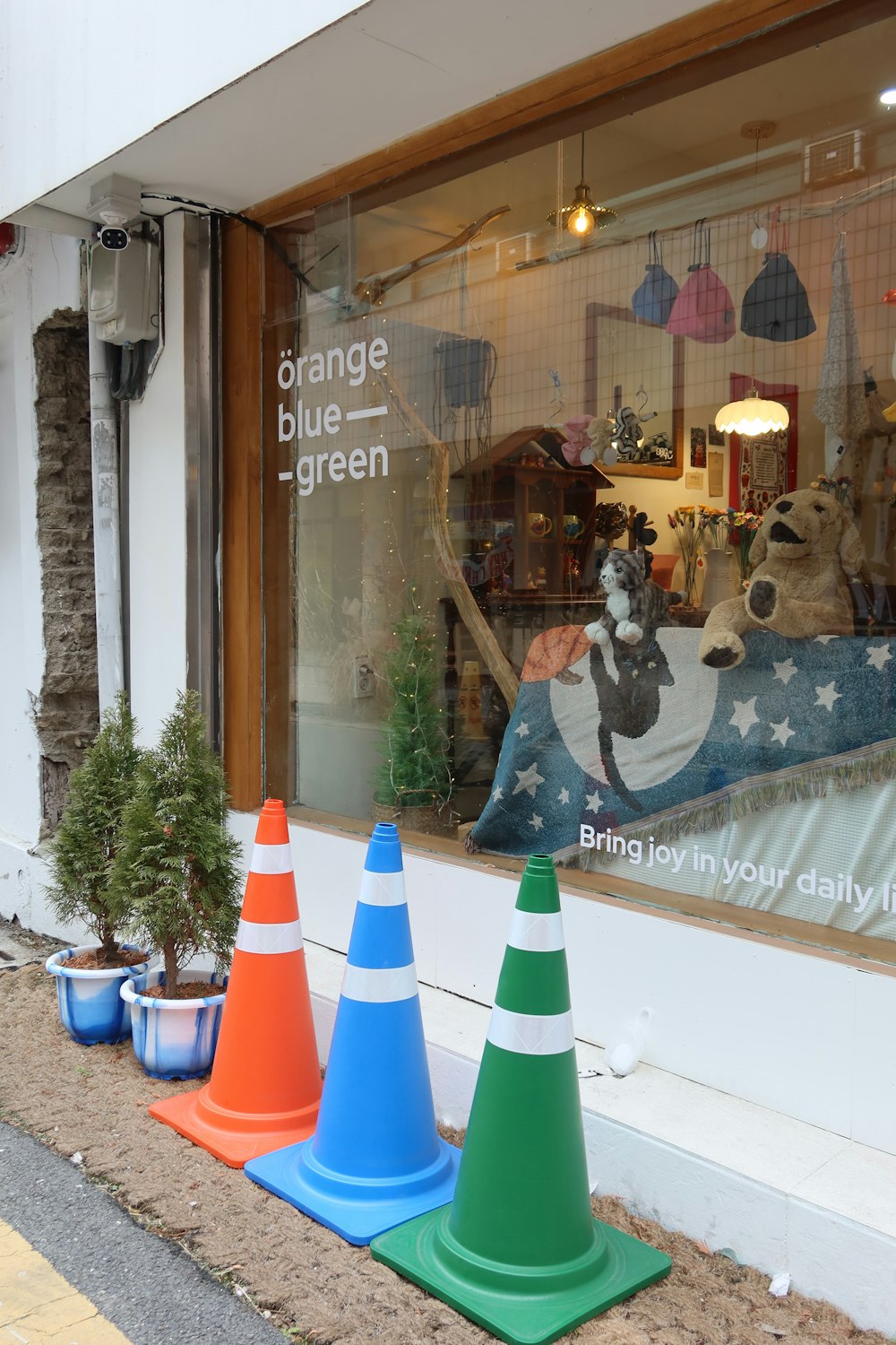 a store front window with traffic cones in front of it