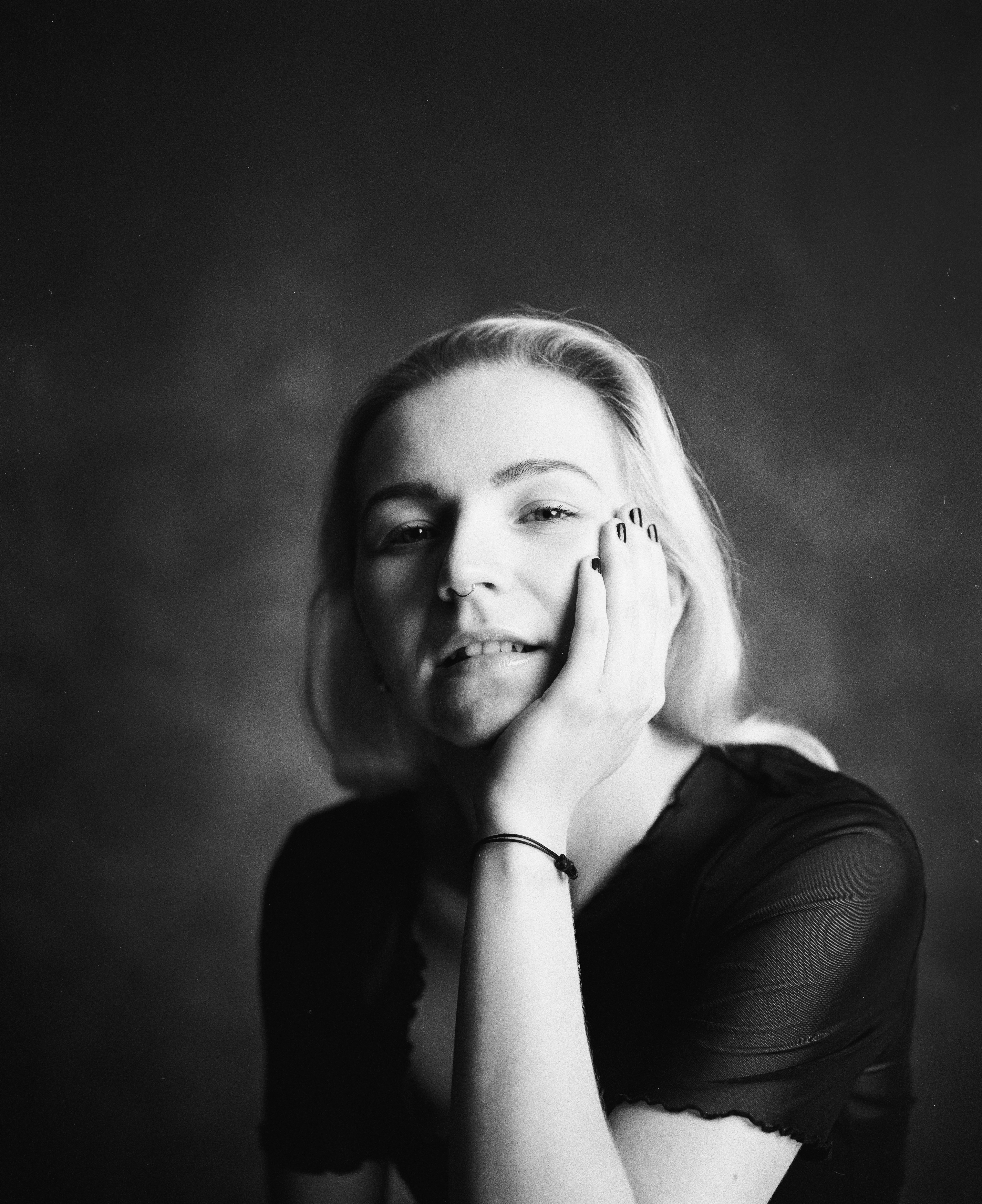 a black and white photo of a woman talking on a cell phone