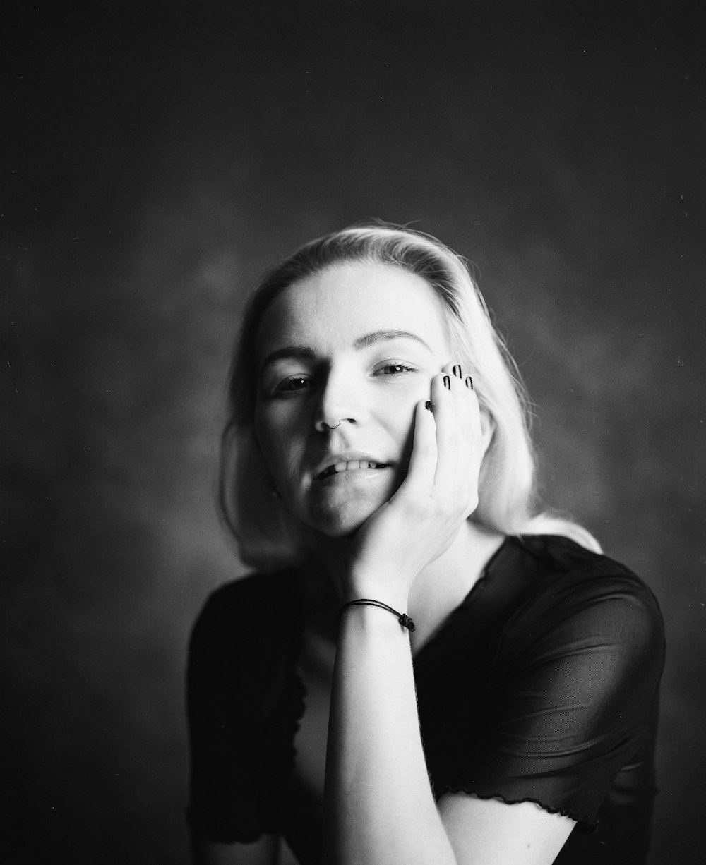 a black and white photo of a woman talking on a cell phone