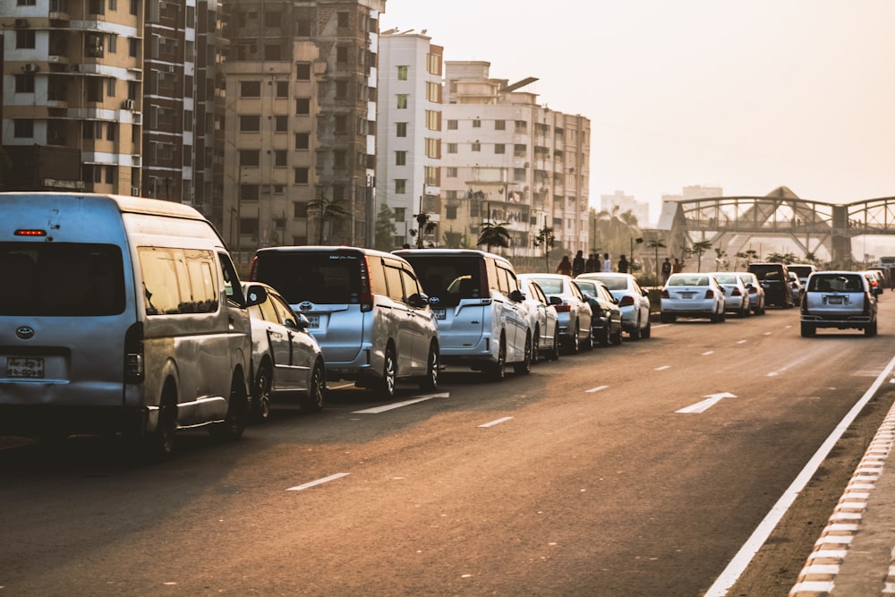 a street filled with lots of traffic next to tall buildings