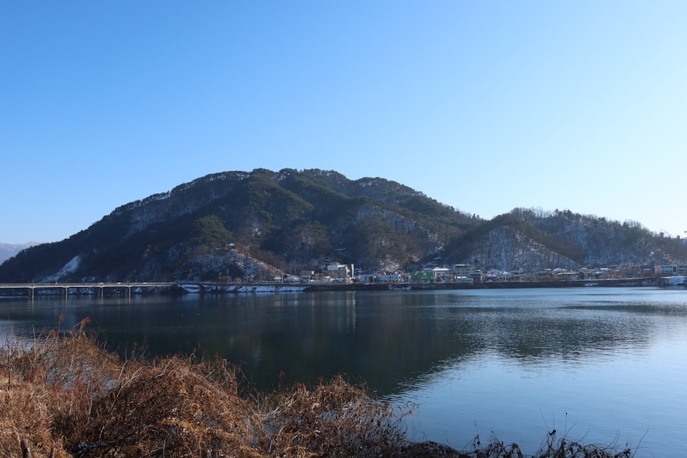 a body of water with a mountain in the background