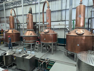 a factory filled with lots of metal tanks