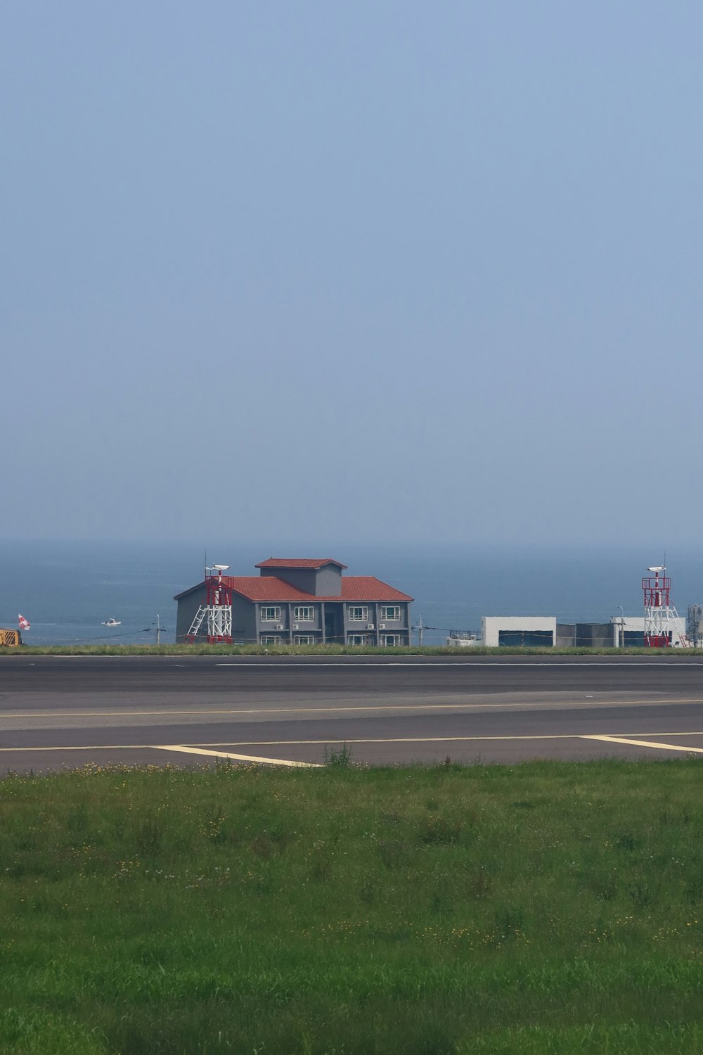 an airport runway with a building in the background