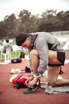 a man tying his shoes before a race