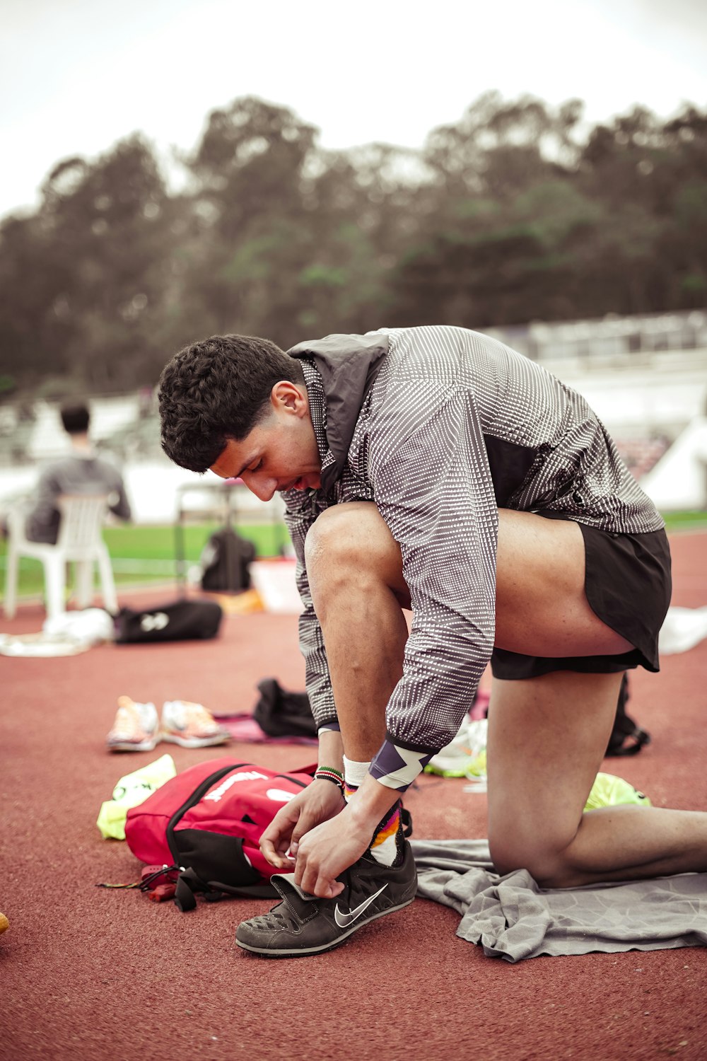a man tying his shoes before a race