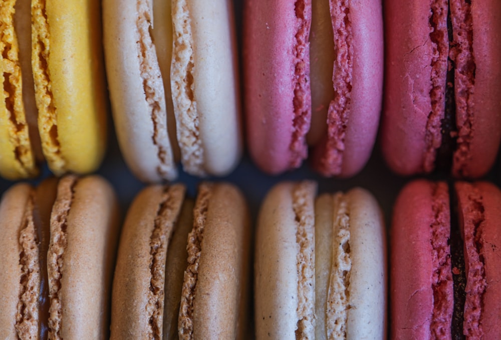 a close up of many different colored macaroons