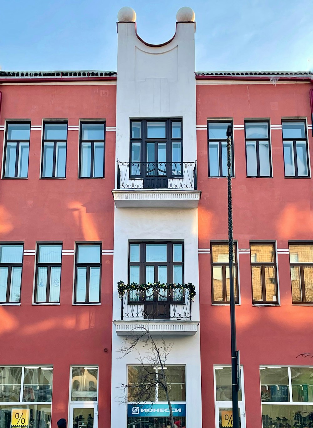 a tall building with many windows and balconies