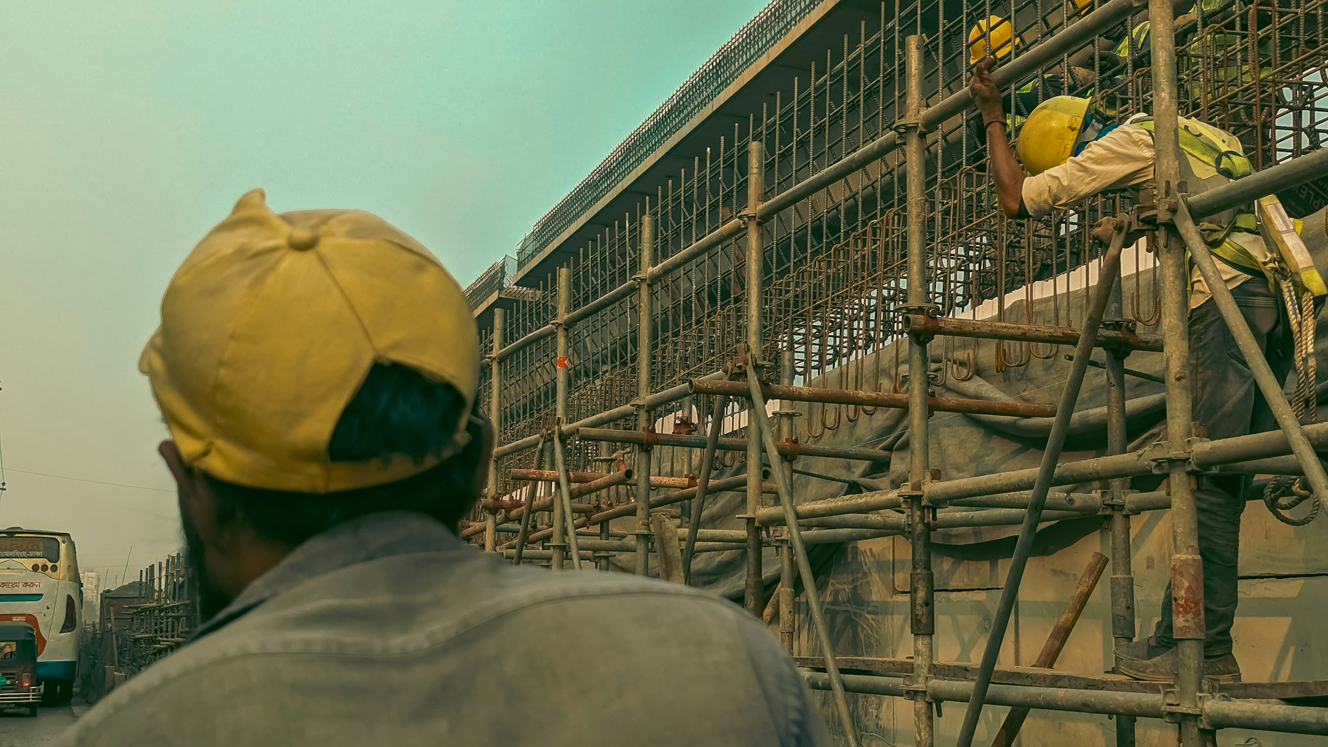 a man standing on a scaffold in front of a building