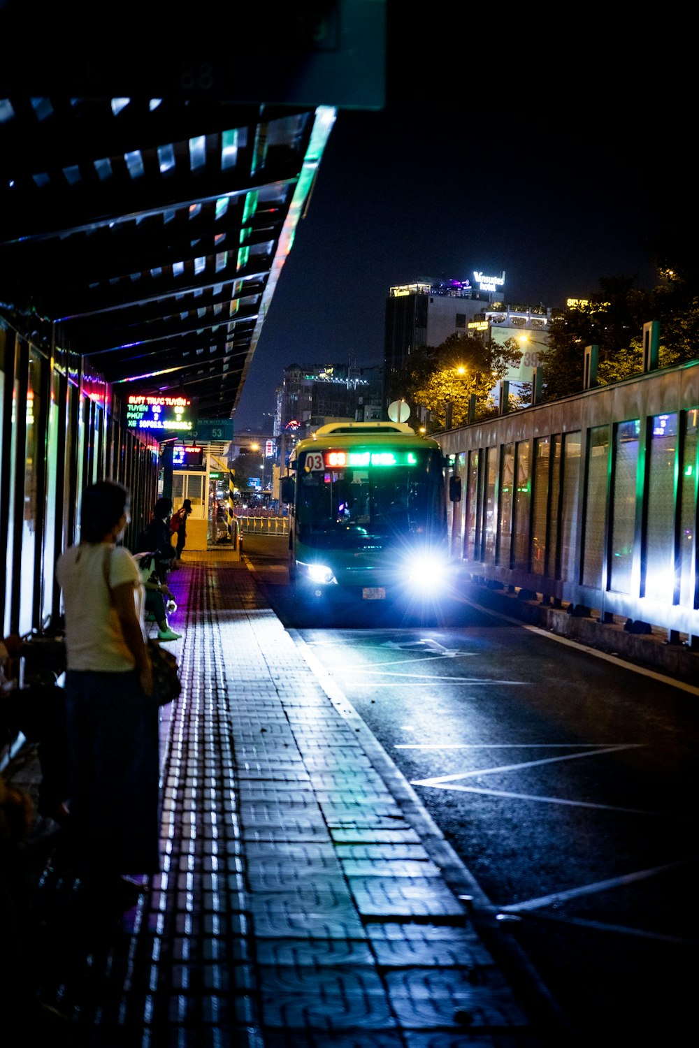 a bus driving down a street at night