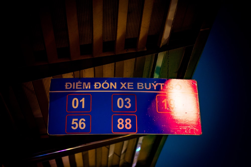 a blue and red sign that reads diem don xe buy