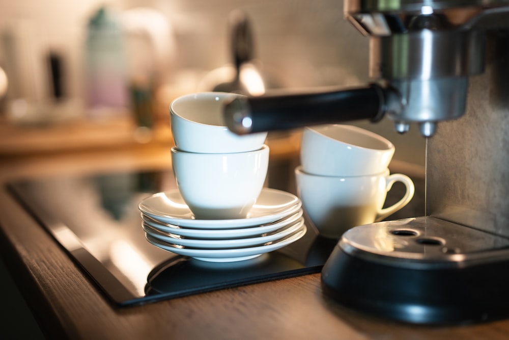 a stack of white cups sitting on top of a counter