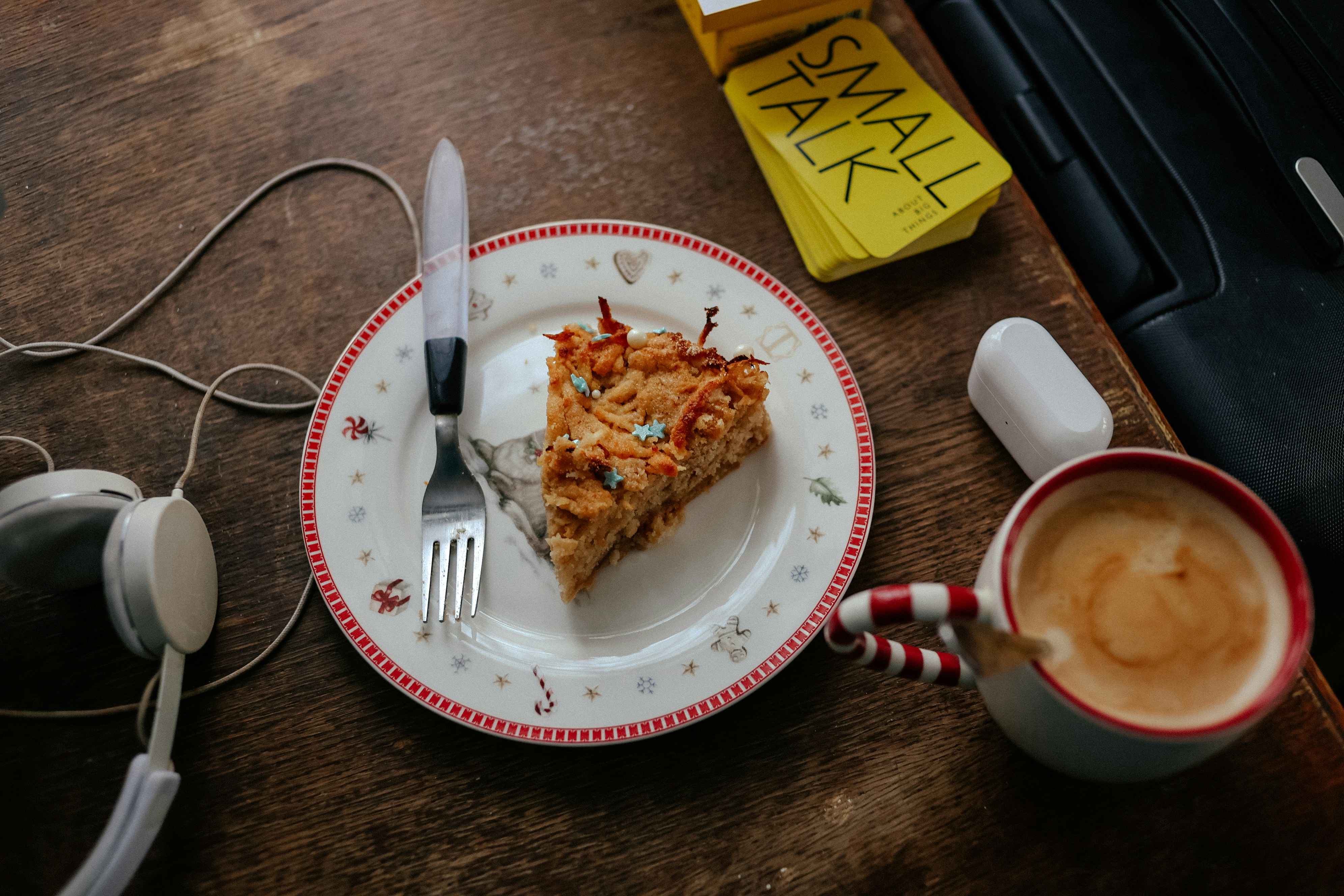 a slice of pizza on a plate next to a cup of coffee