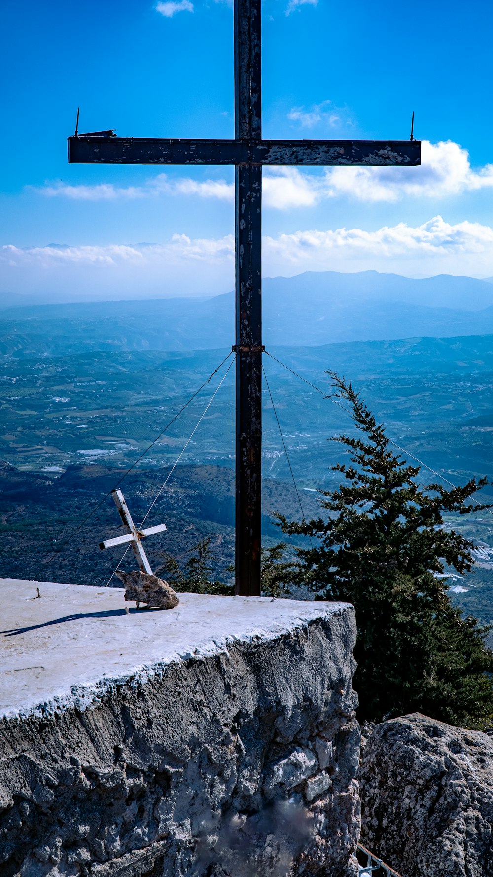 a wooden cross on top of a mountain