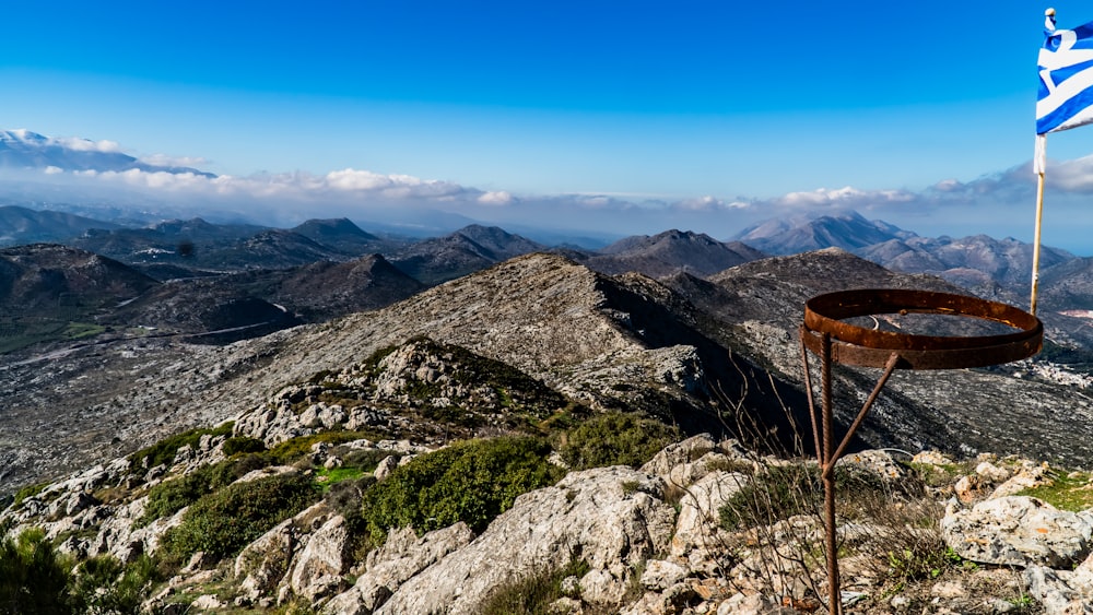 a greek flag on top of a mountain