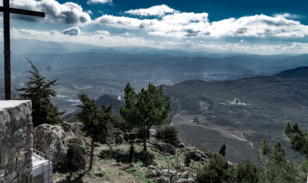 a cross on top of a hill overlooking a valley