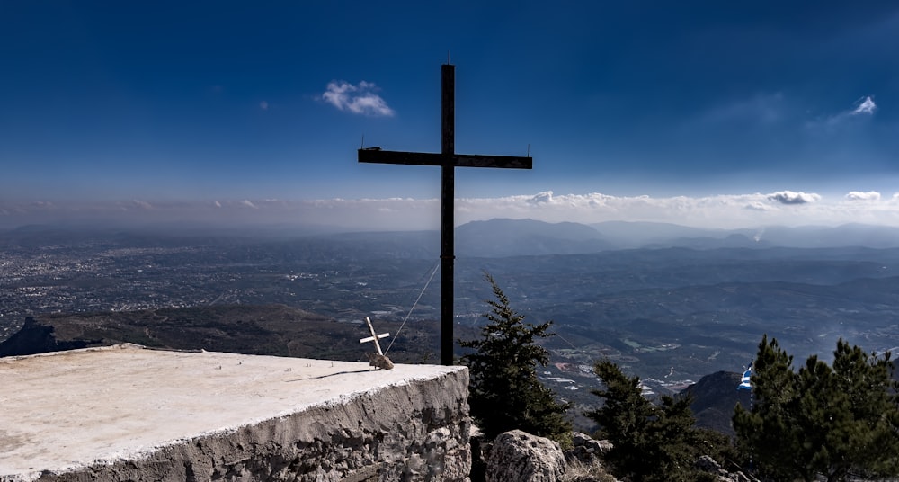 a cross on top of a hill overlooking a city