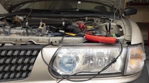 a close up of the front of a car with its hood open