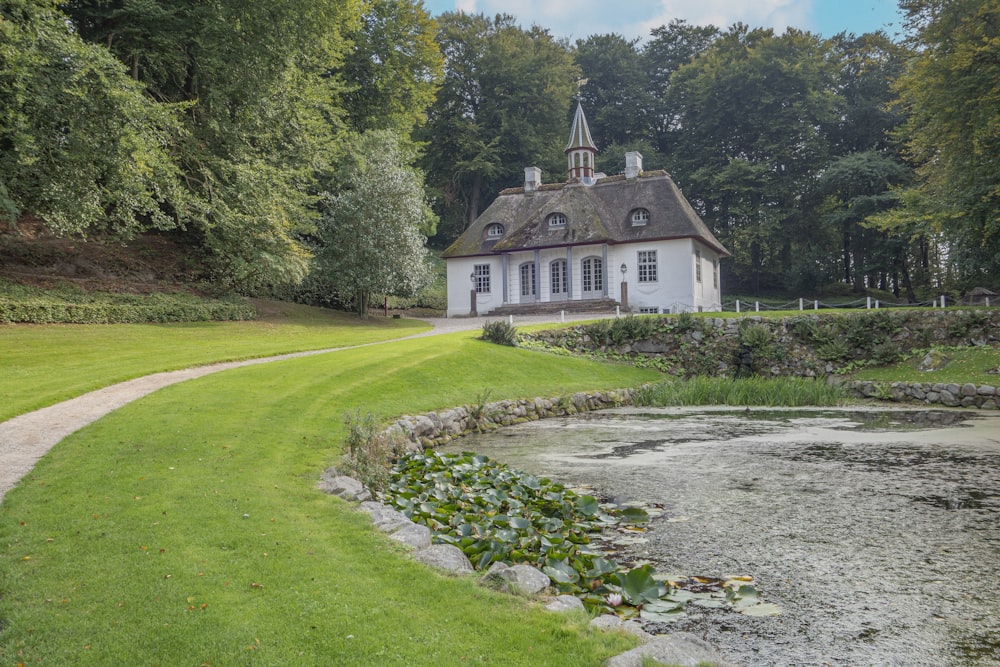 a house with a pond in front of it