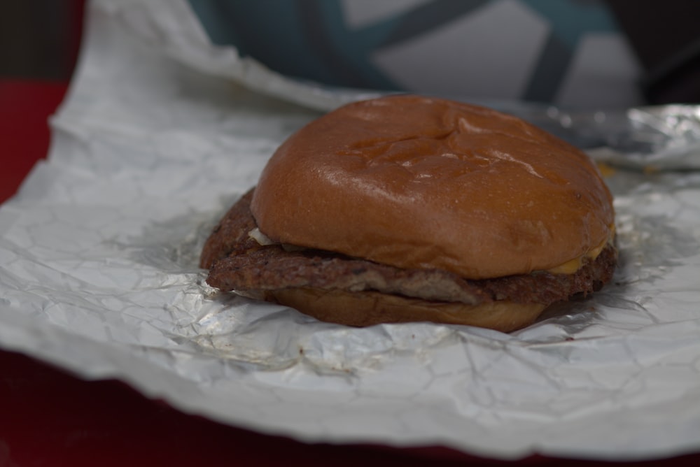 a hamburger sitting on top of a piece of tin foil