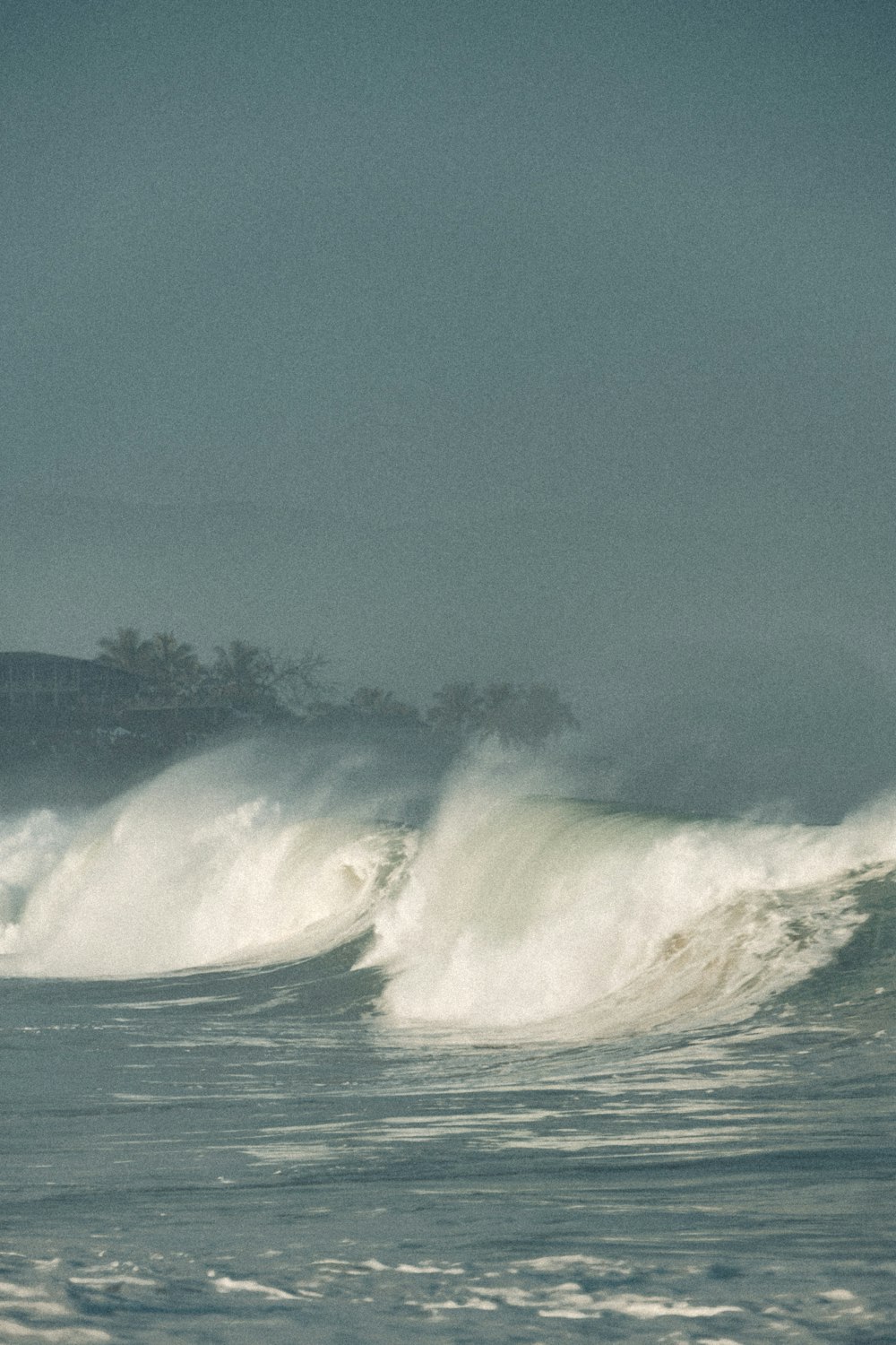 a man riding a wave on top of a surfboard