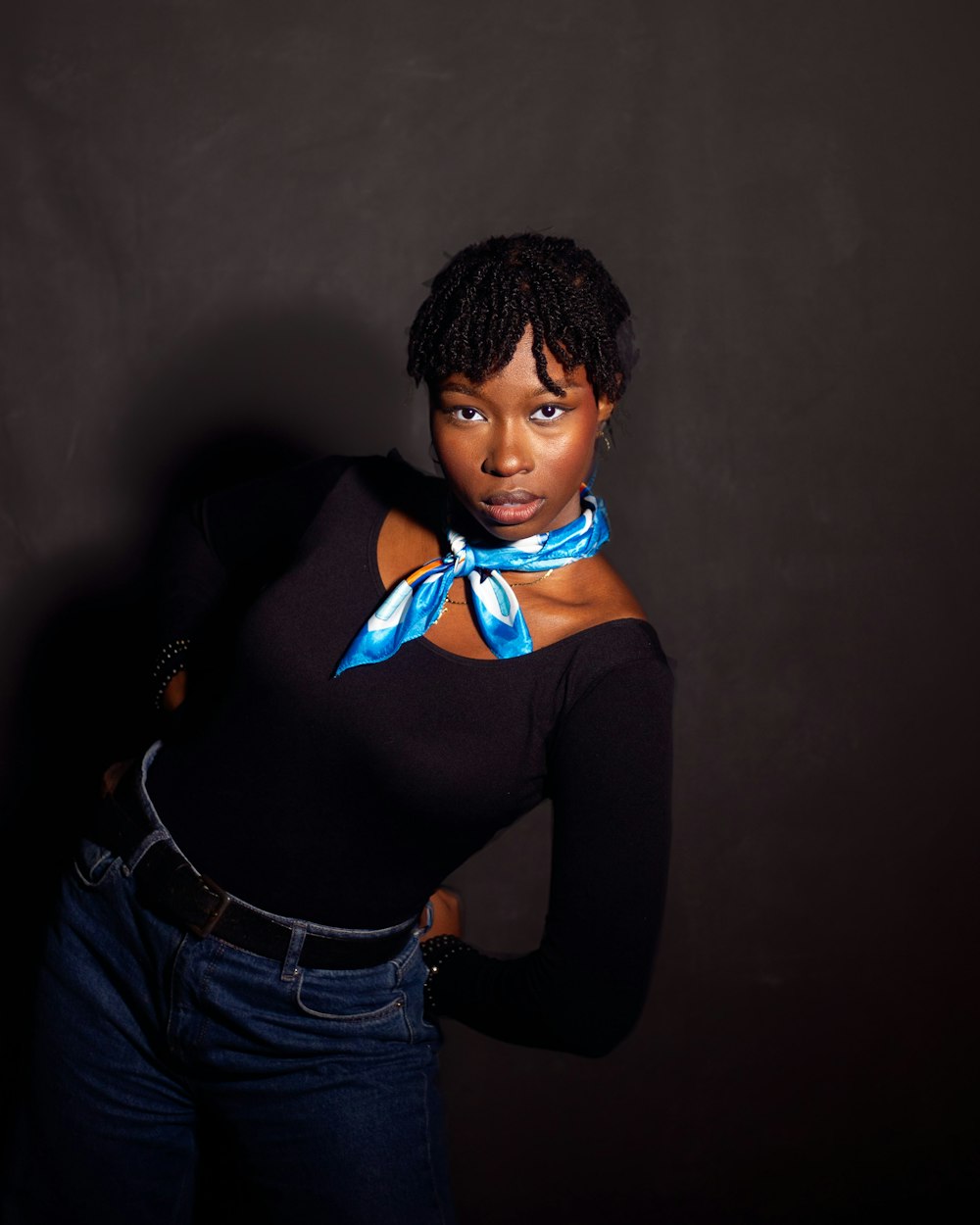 a woman in a black shirt and a blue bow tie