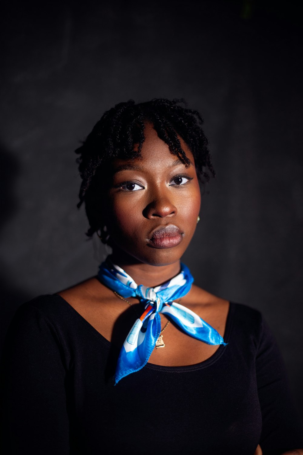 a woman with a blue ribbon around her neck