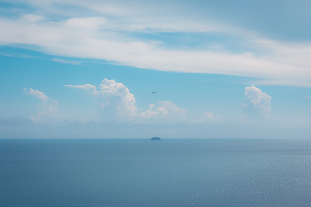 a plane flying over a large body of water