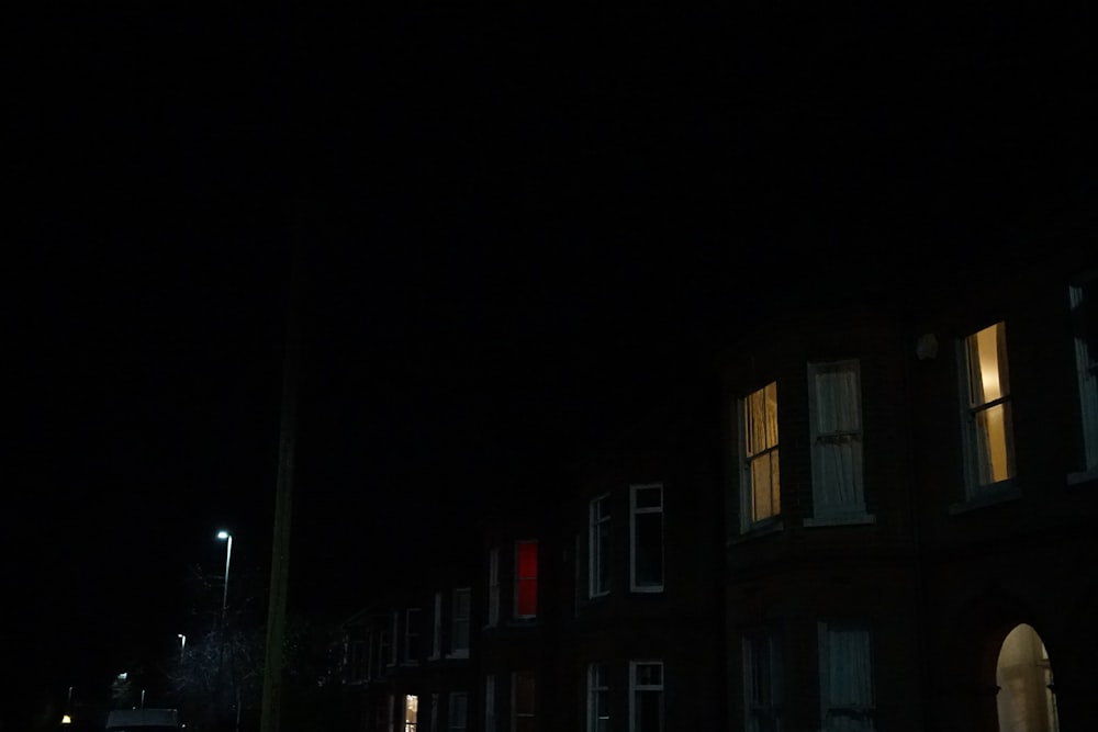 a dark street at night with a traffic light