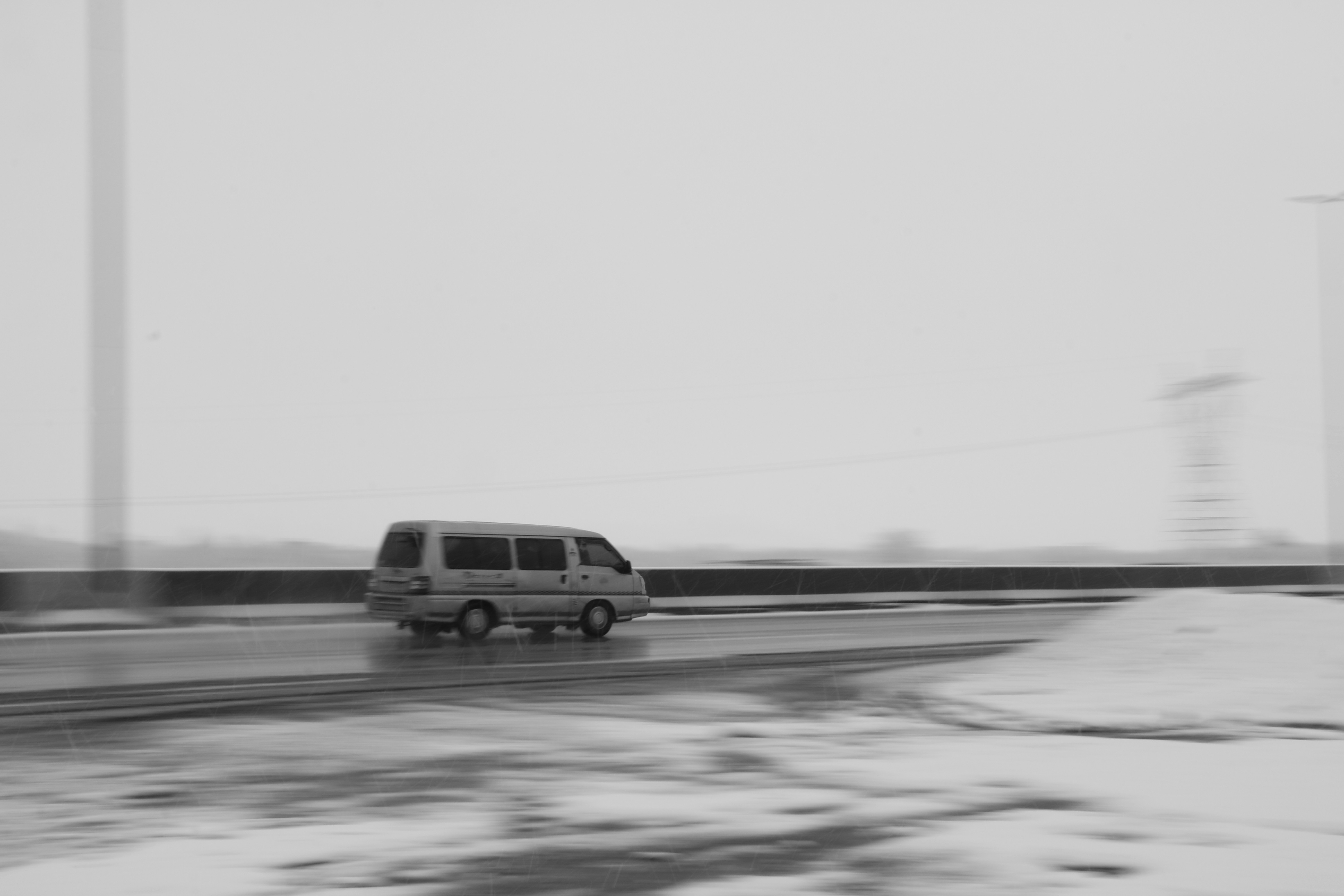 a van is driving down a snowy road