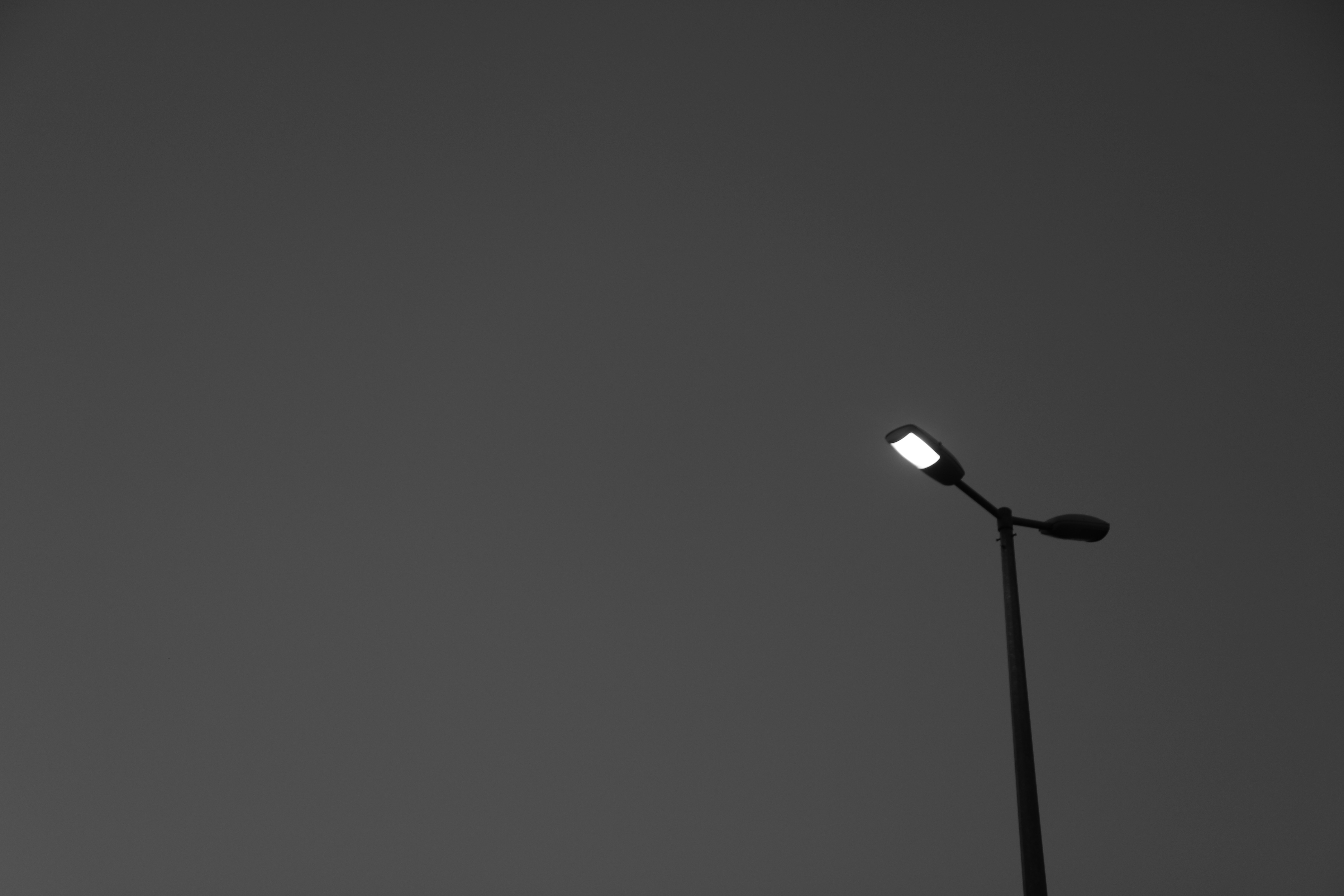 a black and white photo of a street light