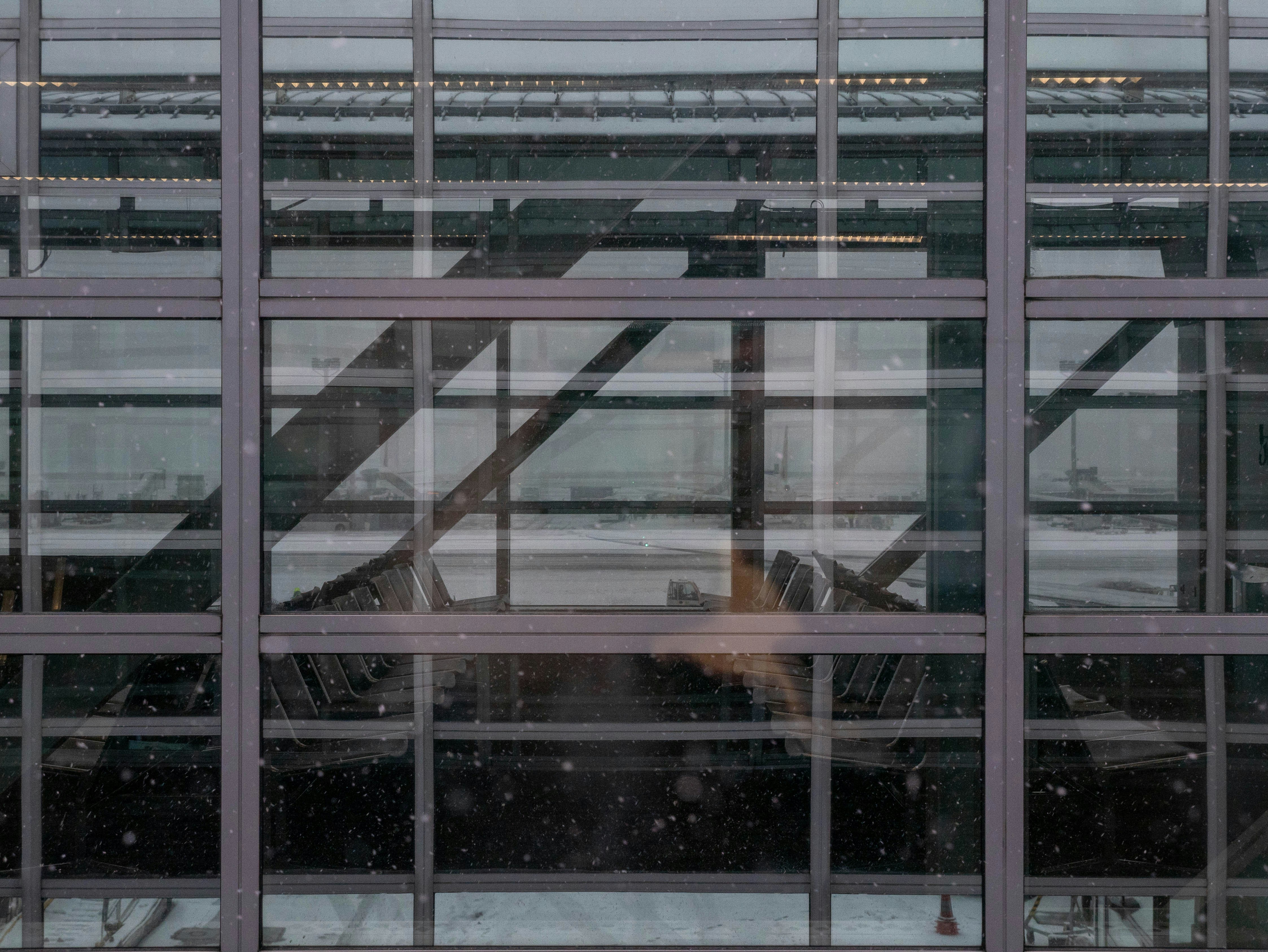 A window with a reflection of an airplane in it photo – Free Snow Image ...