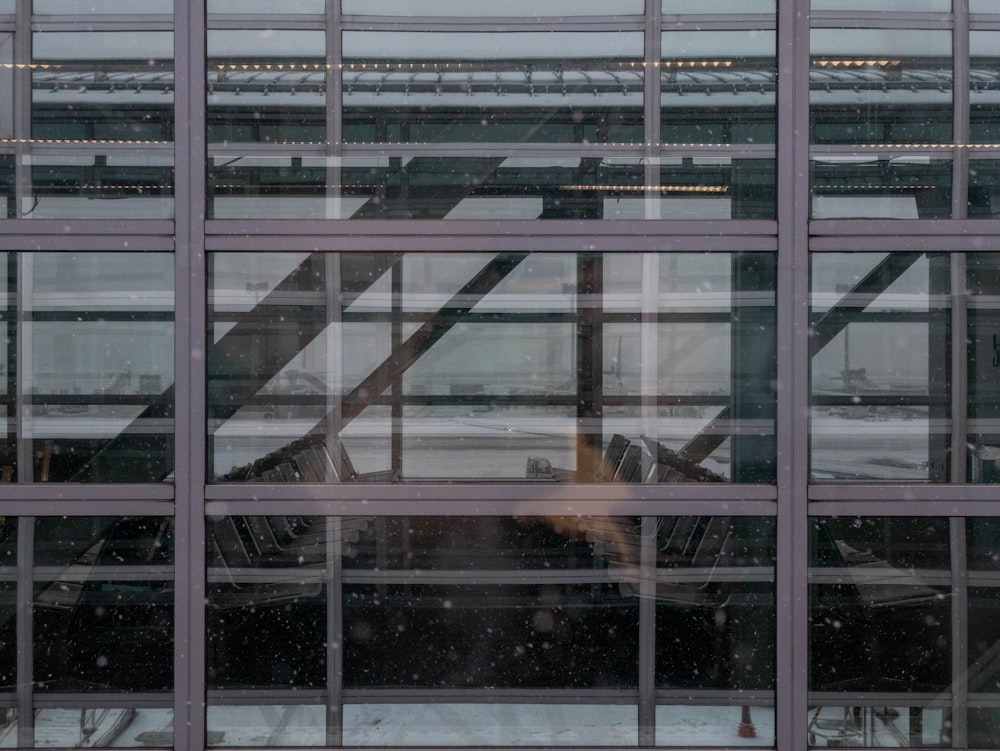 a window with a reflection of an airplane in it