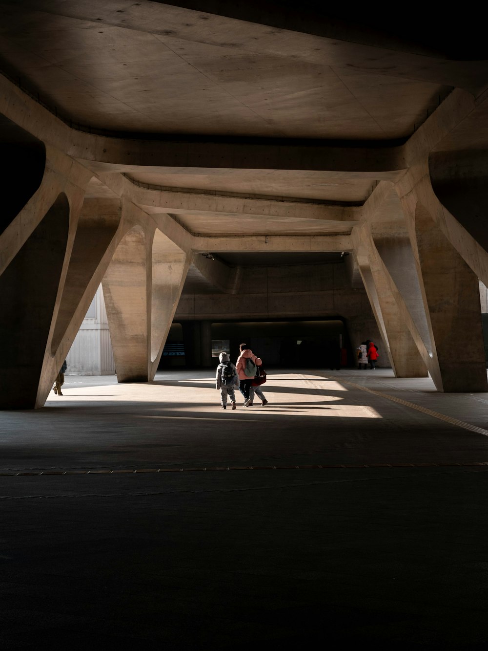 a couple of people that are standing under a bridge