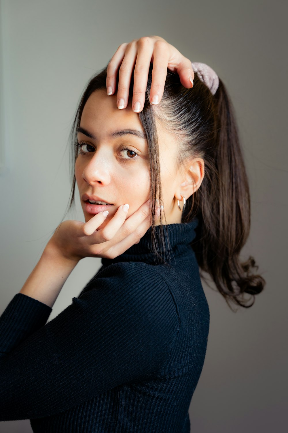 a woman with her hand on her head