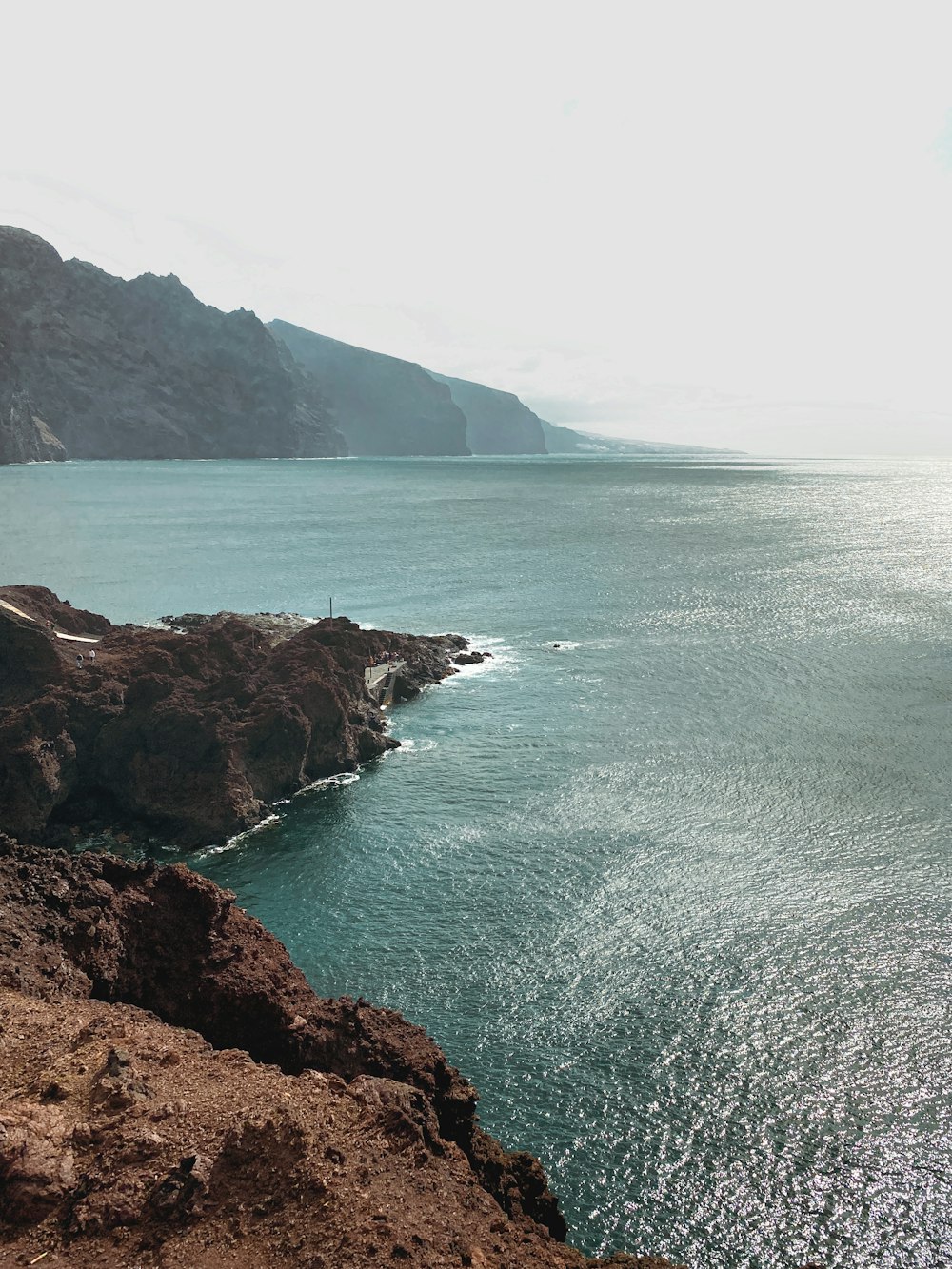 a view of a body of water with a mountain in the background