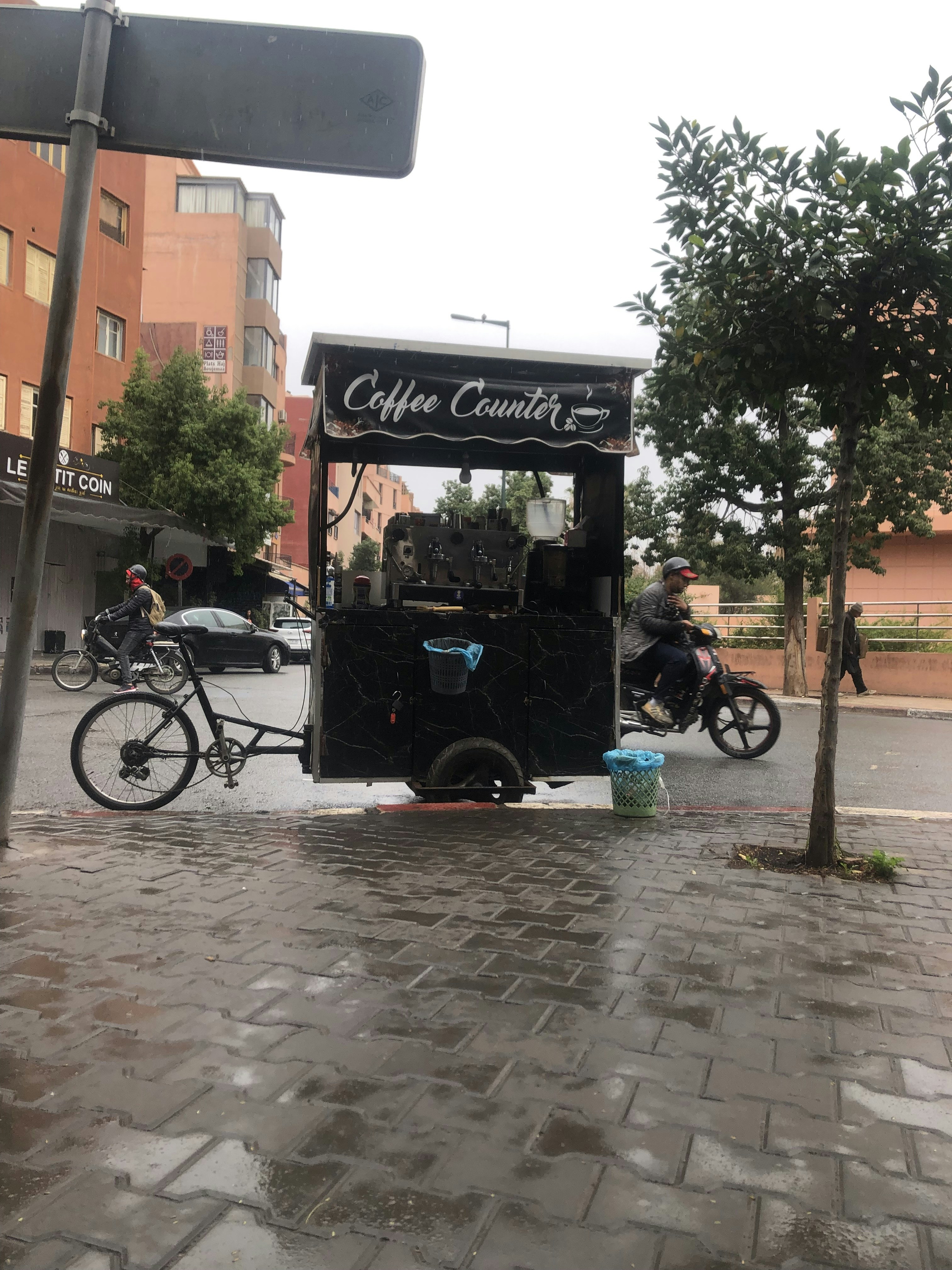 a man riding a bike next to a food truck