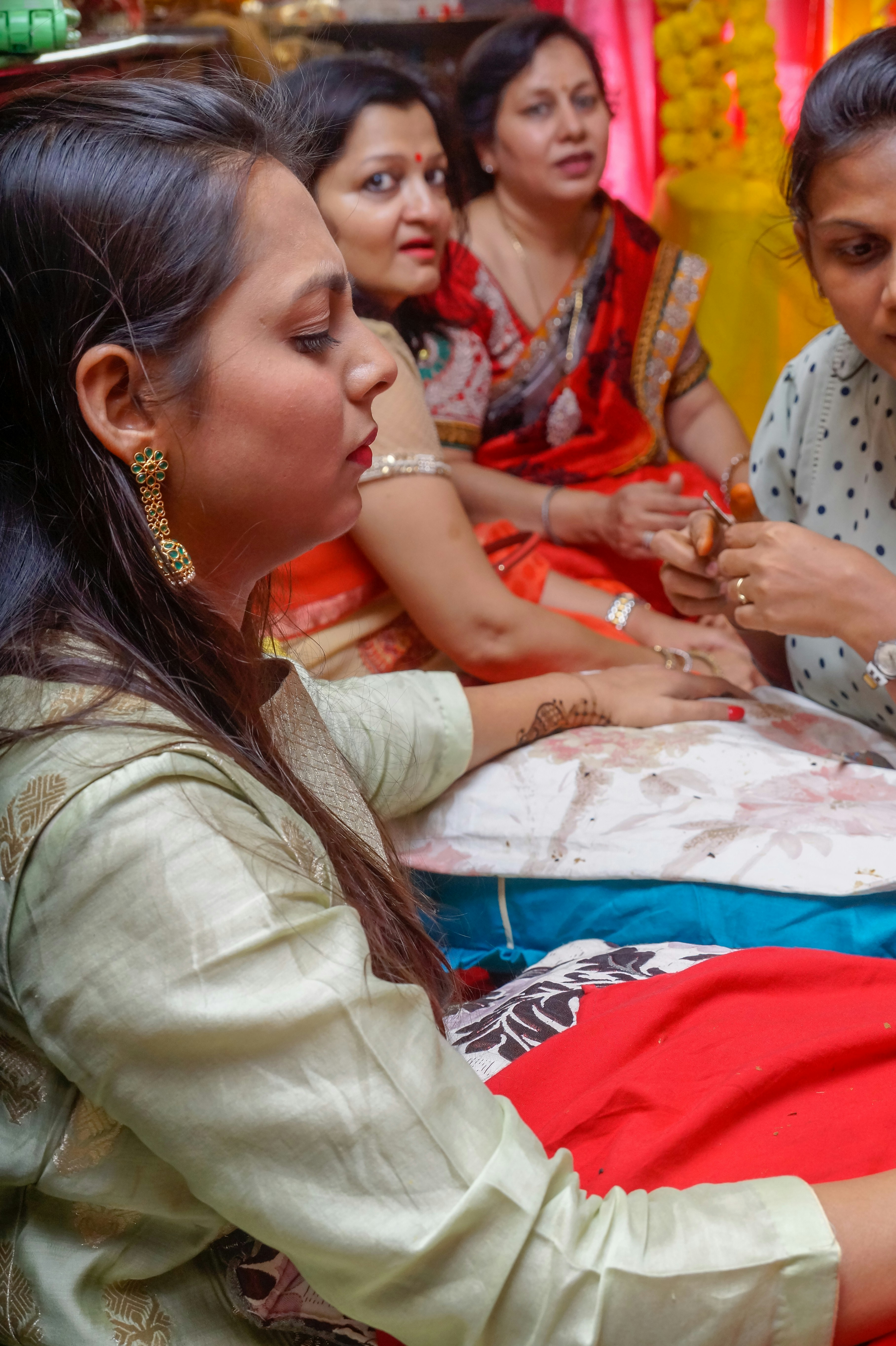 Woman with hair wrapped in towel receiving henna treatment in calm spa environment