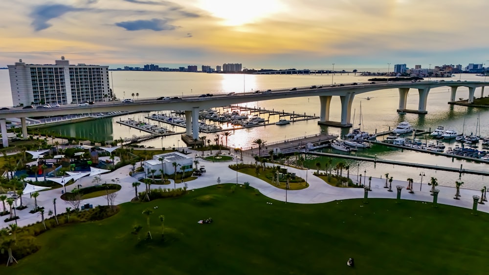 an aerial view of a marina with a bridge in the background