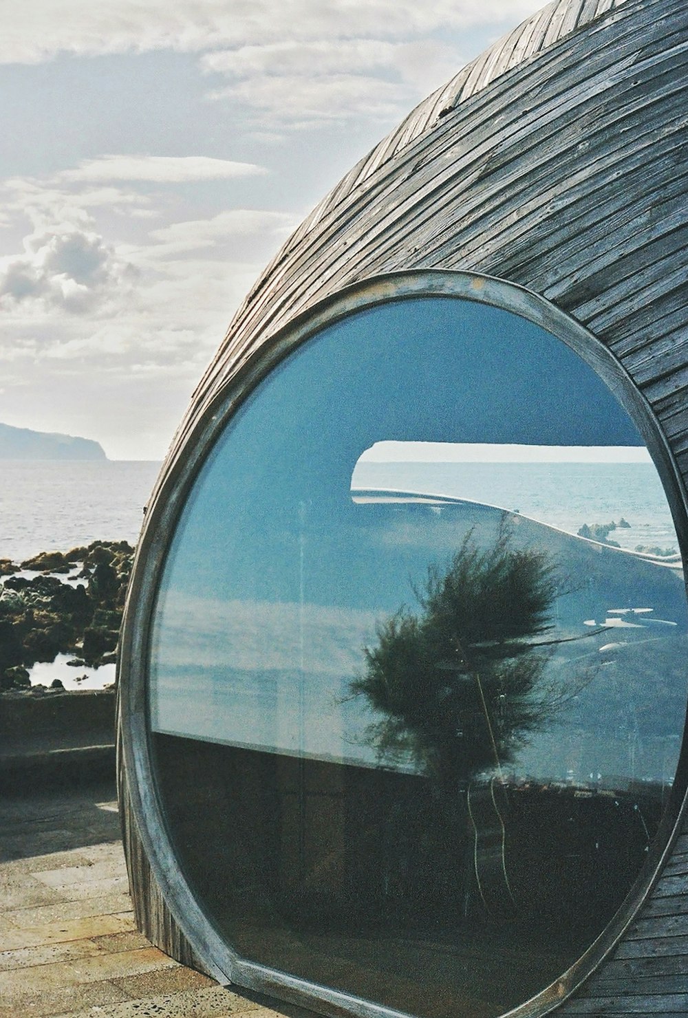 a round mirror on the side of a building